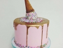 Whimsical gold drip cake with sprinkled ice cream on top | 10 Amazing Drip Cakes - Tinyme Blog