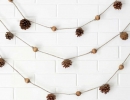 Delicate and earthy wooden bead garland with pine cone | 10 Cute Christmas Crafts - Tinyme Blog