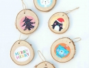 Whimsical birch rounds with quirky art prints | 10 Cute Christmas Ornaments - Tinyme Blog